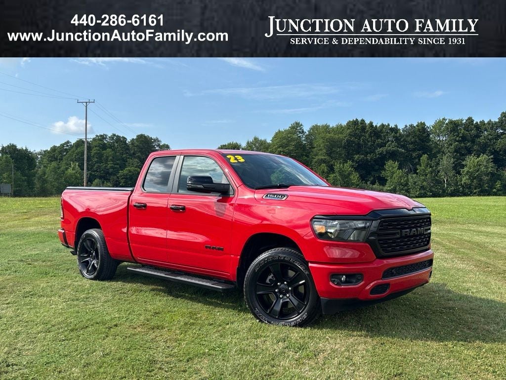 2023 RAM 1500 Big Horn Quad Cab 4x4 6'4' Box in Flame Red Clearcoat — front three-quarter view